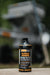MudShield concentrate bottle in front of a MudMixer