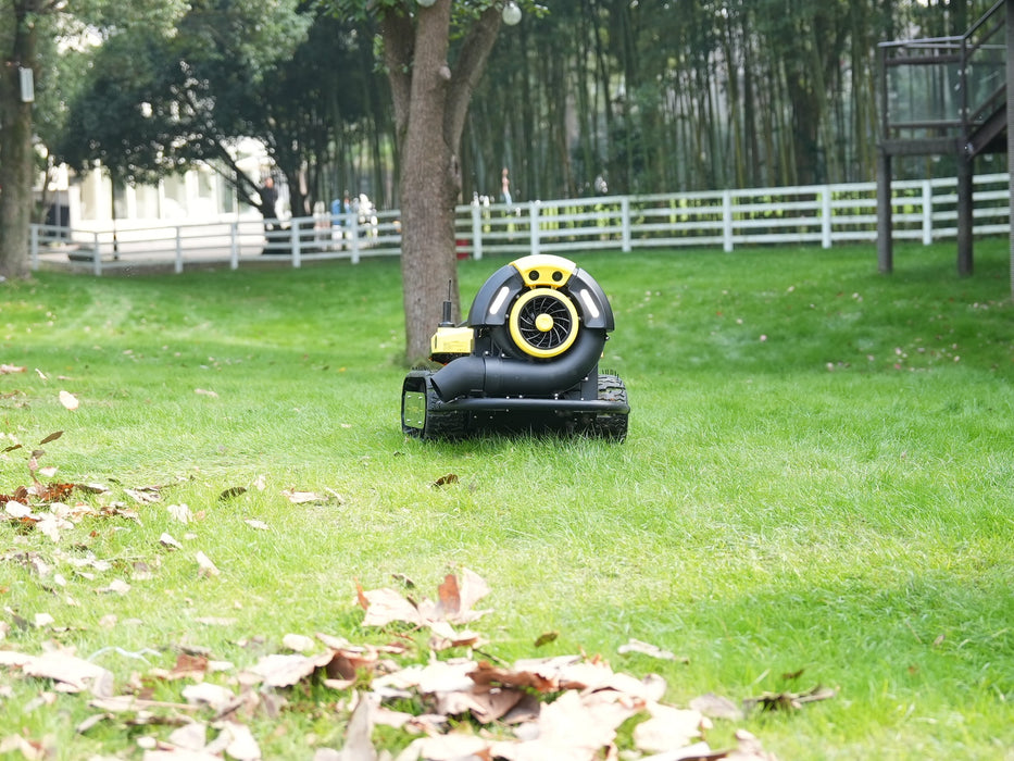 Yarbo blower operating on sloped terrain with tracked drive system