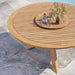 Wellspring 63" Outdoor Patio Teak Wood Dining Table - in lifestyle setting