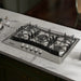 Empava EMPV-30GC21-GX gas cooktop installed in a white marble countertop, kitchen scene