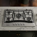 Empava EMPV-30GC21-GX built-in gas cooktop on a kitchen island countertop, angled scene view