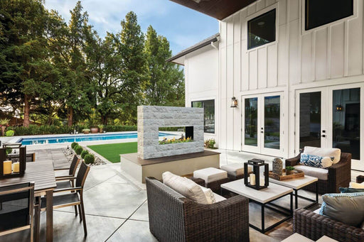Napoleon Galaxy 50 outdoor natural gas fireplace on a covered backyard patio, angled view