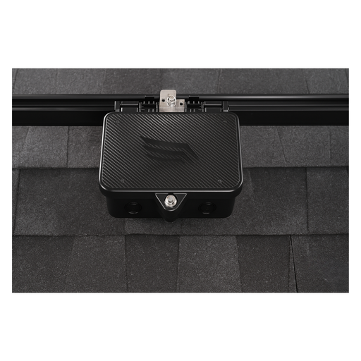 Pegasus Solar - BondBox - Pegasus BondBox installed on a solar rail system over asphalt shingles, showing its durable black metal enclosure securely mounted for system grounding.