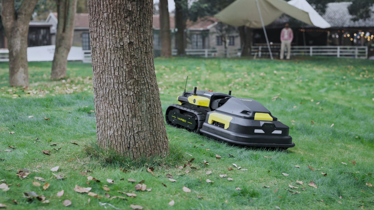 Yarbo mower navigating around garden obstacles in a backyard
