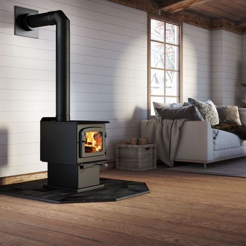 Drolet Escape 1200 N DB03183 wood stove on its pedestal with black stovepipe in a living room