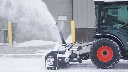Ignite Attachments 3-point snow blower model 60SB on a compact tractor, clearing snow beside a building