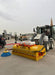 RAMEX DuoSweep bucket sweeper mounted on a tractor outdoors