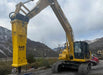 RAMEX RAM hydraulic breaker on a large excavator, side view, representative photo