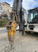 RAMEX RAM hydraulic breaker working beside an excavator cab on a street site, representative photo