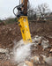 RAMEX RAM hydraulic breaker breaking concrete with dust rising, representative photo