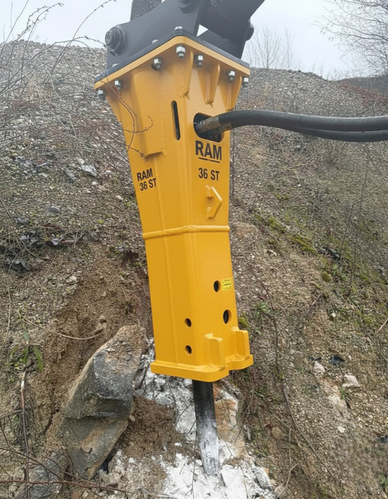 RAMEX RAM hydraulic breaker close-up breaking rock on site, representative photo