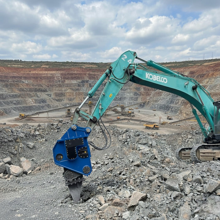 RAMEX RVR vibro ripper on a teal excavator at a rock site