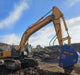 RAMEX RVR vibro ripper on a tracked excavator breaking ground