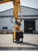RAMEX side-grip vibro hammer mounted on an excavator outside the factory