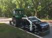 RAMEX SweepTrac road sweeper behind a green tractor on a park road