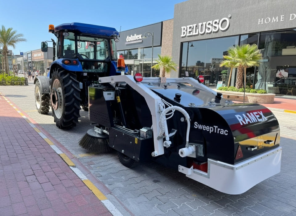 RAMEX SweepTrac road sweeper towed behind a tractor, side view